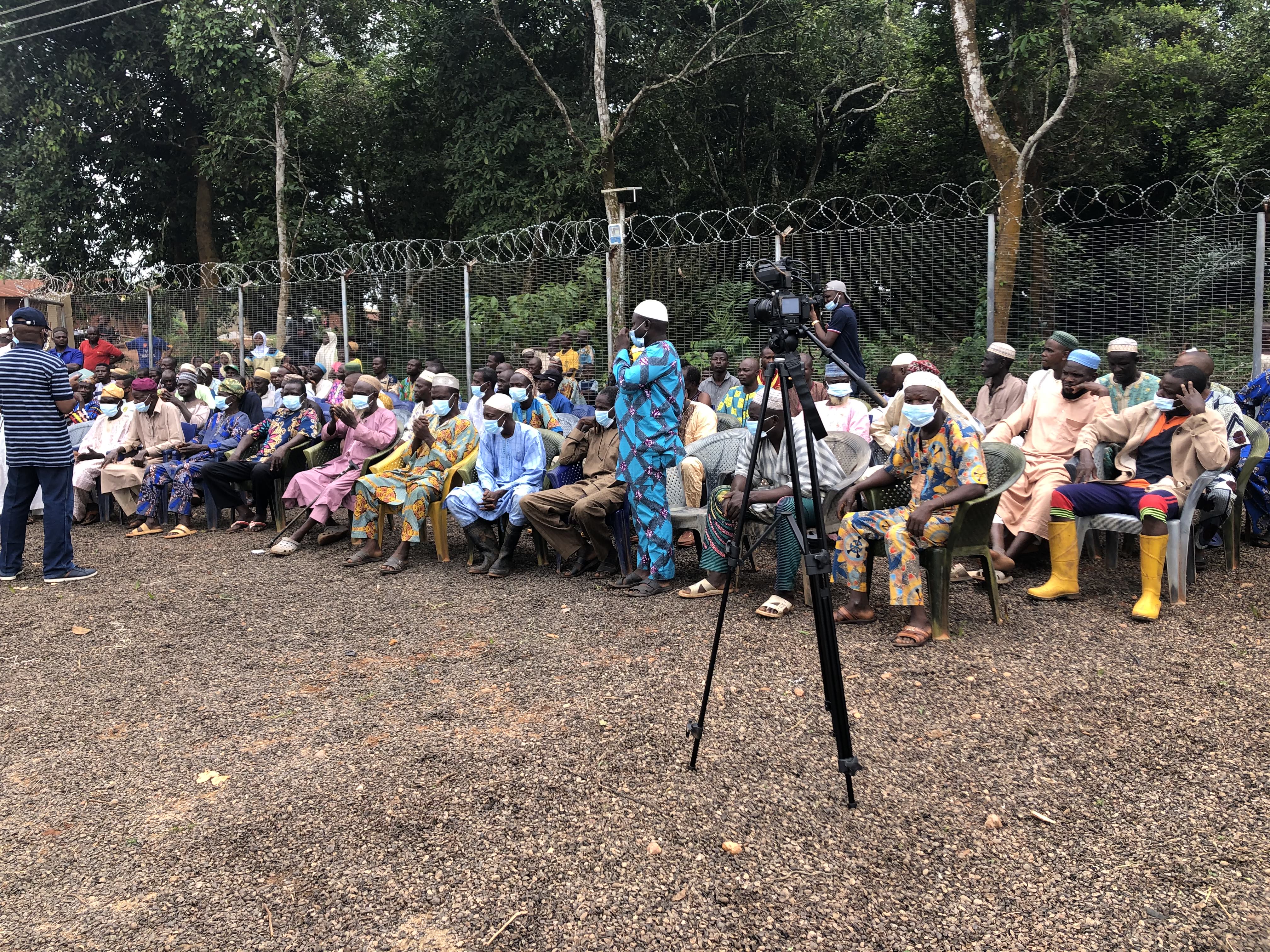 Men gathered for community training and orientation